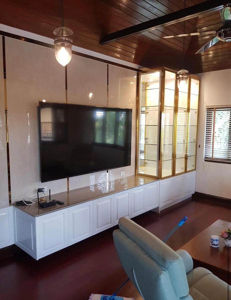 Entertainment center with white lacquer finish and glass display cabinets